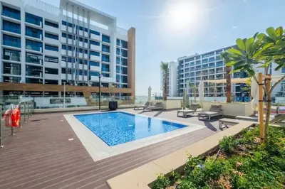 a swimming pool in the middle of a building at Appealing Studio Apartment at Azizi Riviera 34, Al Merkadh by Deluxe Holiday Homes in Dubai
