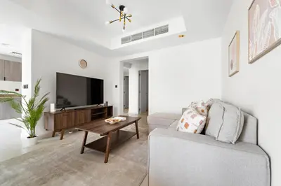 a living room with a couch and a tv at Stonetree - The Springs 5 - Peaceful Community in Dubai