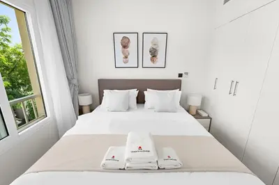 a bedroom with a bed with two towels on it at Stonetree - The Springs 5 - Peaceful Community in Dubai