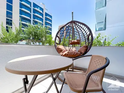 a table and two chairs on a balcony at Elegance at Aziz Riviera Studio & Balcony in Dubai