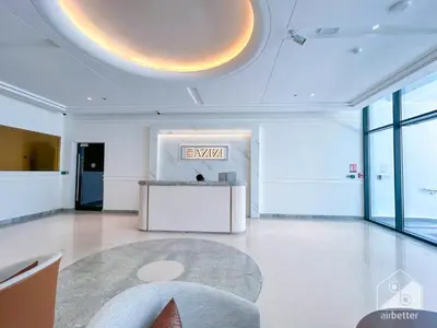 a lobby with an exit sign on the ceiling at Elegance at Aziz Riviera Studio & Balcony in Dubai