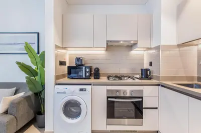 a kitchen with a washing machine and a washer at STAY BY LATINEM Luxury 1BR Holiday Home CV B803 near Burj Khalifa in Dubai