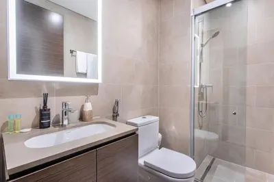 a bathroom with a toilet and a sink and a shower at STAY BY LATINEM Luxury 1BR Holiday Home CV B803 near Burj Khalifa in Dubai