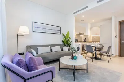 a living room with a couch and a table at STAY BY LATINEM Luxury 1BR Holiday Home CV B803 near Burj Khalifa in Dubai