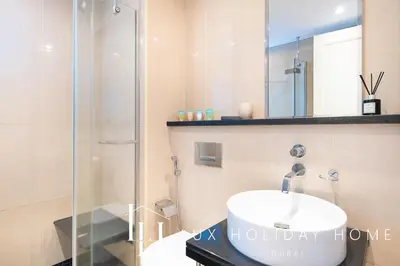 a bathroom with a sink and a glass shower at LUX The Bonnington JLT Suite in Dubai