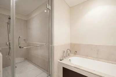 a bathroom with a shower and a bath tub at Lux 1BR,5 Min to Burj Khalifa In heart of Downtown - South Ridge Tower in Dubai