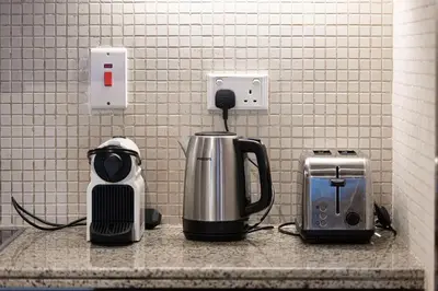 a kitchen counter with a coffee maker and a toaster at Lux 1BR,5 Min to Burj Khalifa In heart of Downtown - South Ridge Tower in Dubai