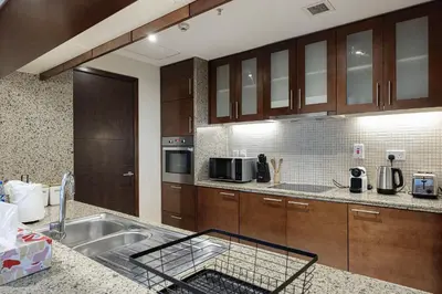 a kitchen with a sink and a counter top at Lux 1BR,5 Min to Burj Khalifa In heart of Downtown - South Ridge Tower in Dubai