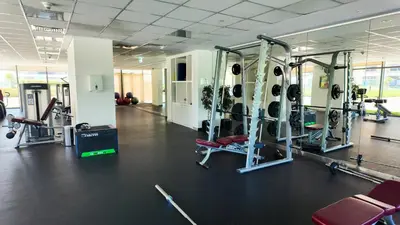 a gym with several tread machines in a room at Luxurious New Brand 2Br at Mulberry 2 at Park Heights Building A2 - Dubai Hills in Dubai