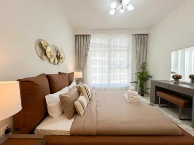 a living room with a couch and a desk at Luxurious New Brand 2Br at Mulberry 2 at Park Heights Building A2 - Dubai Hills in Dubai