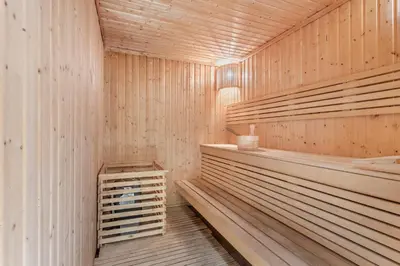 a sauna with wooden walls and wooden shelves at STAY BY LATINEM Luxury 1BR Holiday Home CVR A609 near Burj Khalifa in Dubai