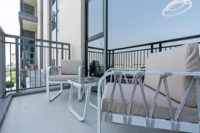 a balcony with a bed and a table and chairs at GLOBALSTAY Creek Rise Tower Elegant Apartments in Dubai