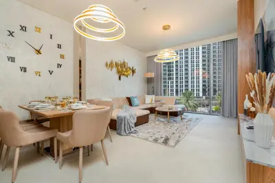 a living room with a table and chairs and a couch at GLOBALSTAY Creek Rise Tower Elegant Apartments in Dubai