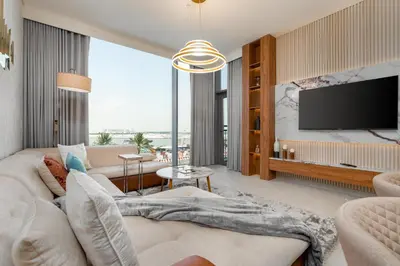 a living room with a couch and a tv at GLOBALSTAY Creek Rise Tower Elegant Apartments in Dubai
