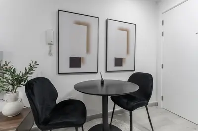 a dining room with two chairs and a table at HAVN - Studio with Lake Views in Dubai Gate, JLT in Dubai