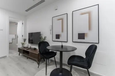 a dining room with a table and two chairs at HAVN - Studio with Lake Views in Dubai Gate, JLT in Dubai