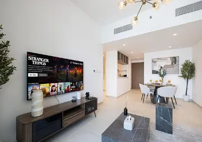 a living room with a large flat screen tv on a wall at Downtown Burj Khalifa View 2BR Apartment in Dubai