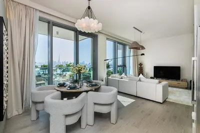 a living room with a table and chairs at Burj Khalifa view & Creek sea view in Dubai