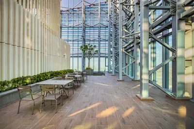 a cafeteria with tables and chairs in a building at Burj Khalifa view & Creek sea view in Dubai