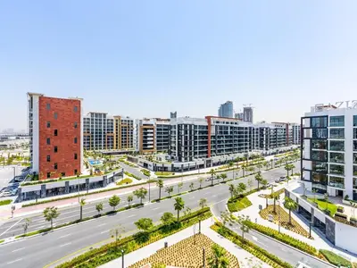 an empty street in a city with tall buildings at Zen Condo With Burj Khalifa View In Vibrant City in Dubai