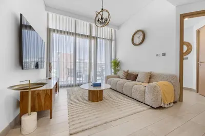 a living room with a couch and a table at Zen Condo With Burj Khalifa View In Vibrant City in Dubai