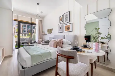 a bedroom with a bed and a table and a dining room at GuestReady - Downtown Dubai luxurious living in Dubai