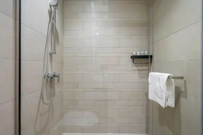 a bathroom with a shower with a glass door at GuestReady - Downtown Dubai luxurious living in Dubai