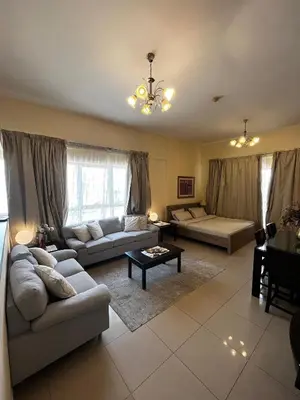 a living room with two couches and a table at Ashri HH, Studio in JVC in Dubai