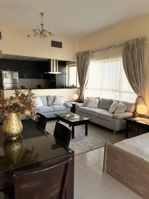 a living room with a couch and a table at Ashri HH, Studio in JVC in Dubai