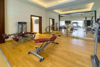 a gym with several exercise equipment in a room at City skyline view I Super-fast Wi-fi I Downtown in Dubai