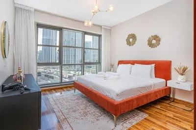 a bedroom with a bed and a large window at City skyline view I Super-fast Wi-fi I Downtown in Dubai