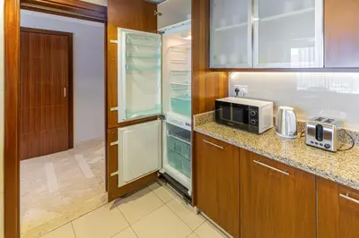 a kitchen with a refrigerator and a microwave at City skyline view I Super-fast Wi-fi I Downtown in Dubai