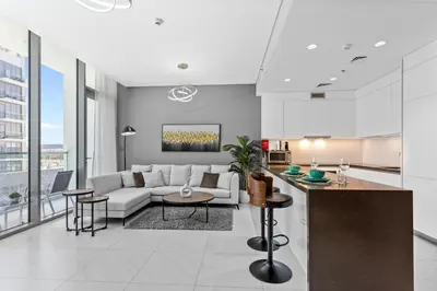 a living room with a couch and a table at Premium 1-BR with Exquisite Layout in District One in Dubai