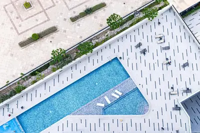 an overhead view of a swimming pool with tables and chairs at Cozy Central Home with Full Burj View in Dubai