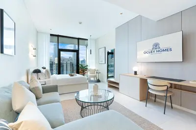 a living room with a couch and a table at Cozy Central Home with Full Burj View in Dubai
