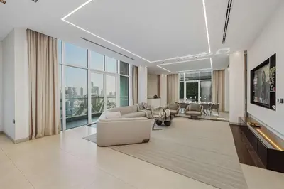 a living room with a couch and chairs and a table at Palm Penthouse Sky Villa - Vast Terrace & Jacuzzi by Exclusive Holiday Homes in Dubai