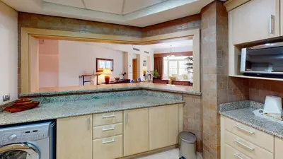 a large kitchen with a washer and dryer at Dabas Palm Shores Elegant Four Beds in Dubai