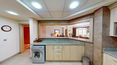 a large kitchen with a washer and dryer at Dabas Palm Shores Elegant Four Beds in Dubai