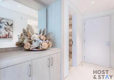 a vase of flowers on a counter in a hallway at Luxurious 1BR Palm Seven, Palm Jumeirah in Dubai