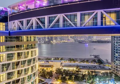an aerial view of a building with a river and a bridge at Luxurious 1BR Palm Seven, Palm Jumeirah in Dubai