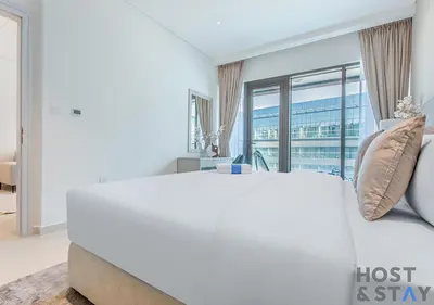 a large white bed in a room with a large window at Luxurious 1BR Palm Seven, Palm Jumeirah in Dubai