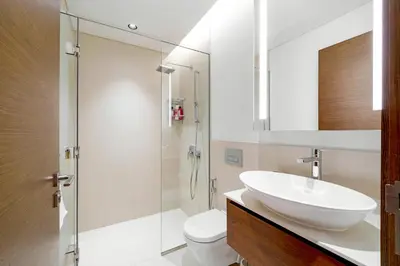 a white bathroom with a sink and a toilet at Experience City Walk - Spacious Haven - 2 Bedroom plus Maid's Room in Dubai