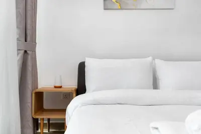 a bedroom with a bed and a side table at Nice studio in Al Furjan - Dubai in Dubai