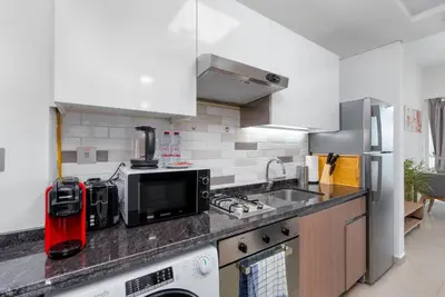 a kitchen with a counter top with a sink and a microwave at Nice studio in Al Furjan - Dubai in Dubai