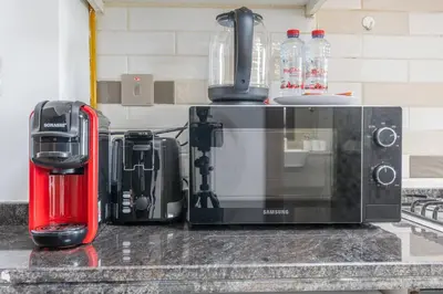 a kitchen counter with a microwave and a coffee maker at Nice studio in Al Furjan - Dubai in Dubai