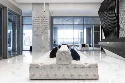 a person laying on a bed in a room at GLOBALSTAY J One Tower Apartments at Pearl of UAE in Dubai