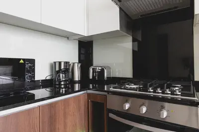 a kitchen with a stove and a stove top oven at GLOBALSTAY J One Tower Apartments at Pearl of UAE in Dubai