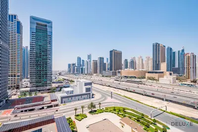 a view of a city with a highway and buildings at Unbeatable Price, Luxury 1BR, Limited Time Offer by Deluxe Holiday Homes in Dubai