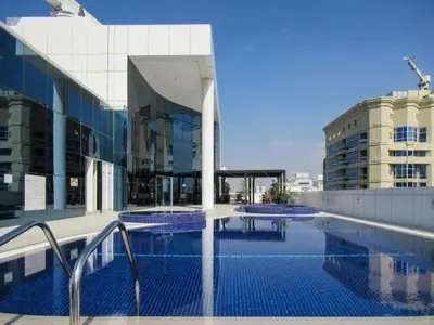 a swimming pool on the roof of a building at Unbeatable Price, Luxury 1BR, Limited Time Offer by Deluxe Holiday Homes in Dubai