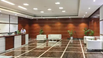 a lobby of a hotel with white chairs and a counter at Unbeatable Price, Luxury 1BR, Limited Time Offer by Deluxe Holiday Homes in Dubai